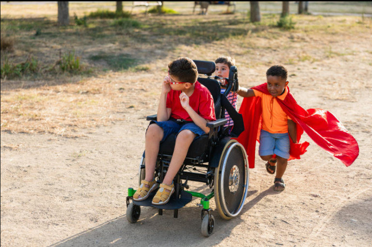 After school club registration in Scotland: children playing outdoors, one in a wheelchair